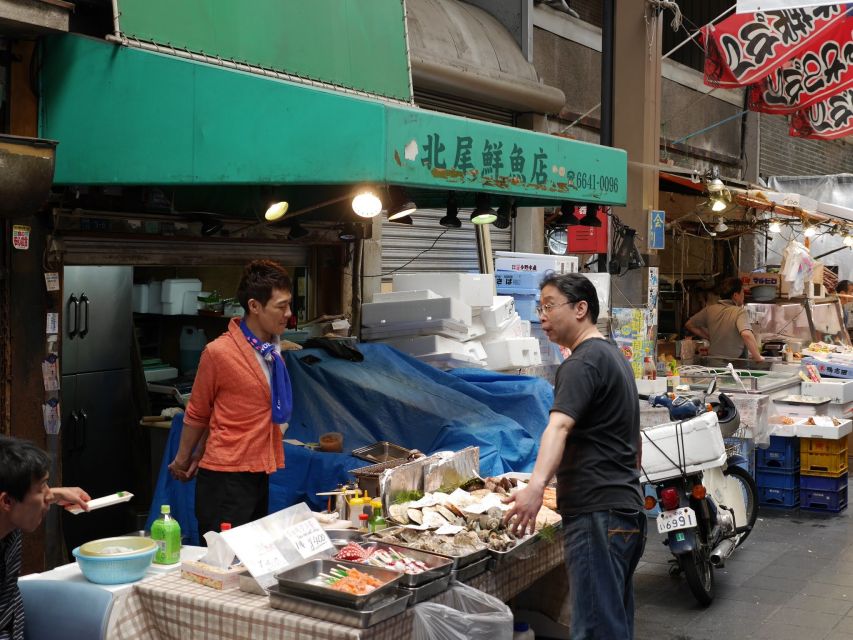 Osaka: Full-Day Sightseeing Tour by Private Vehicle - Shinsekai street scene: foods, games, and Osaka style